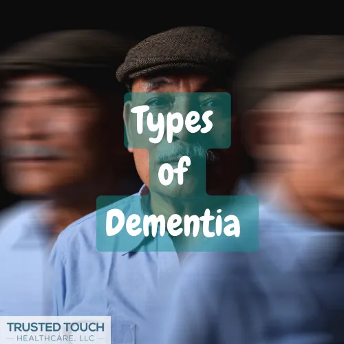 Close-up of a man in a light-blue collared shirt, wearing a dark-colored cap. Overlaid on the image are the words "Types of Dementia" in a teal-colored, bold, sans-serif font. The words are positioned centrally above and a bit below the man's face.